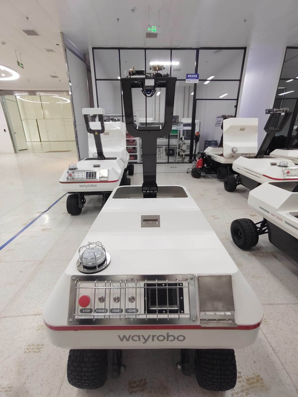 WayRobo autonomous golf ball collection robot operating on a UK driving range at dusk